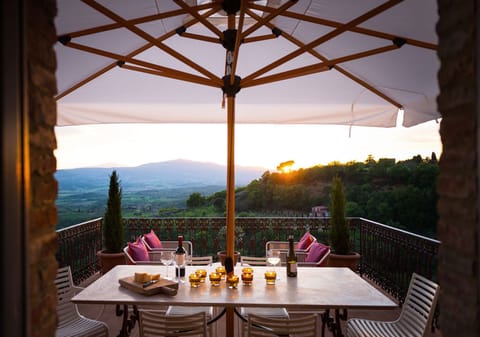 View from the kitchen terrace with outdoor dining table and lounge