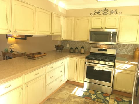 Large kitchen with stainless appliances.