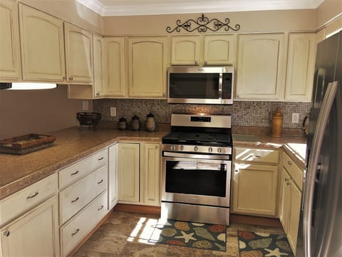 New stainless appliances. Cream glazed cabinets. 