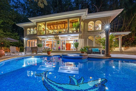 As night falls, the home glows softly, creating a warm and welcoming atmosphere