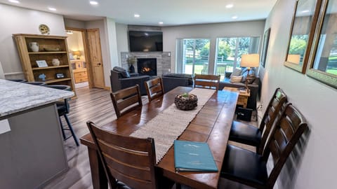 Living room with sofa bed, gas fireplace, and balcony w/ propane BBQ grill