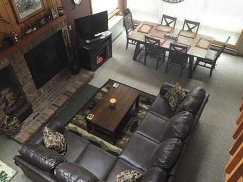 Overview of living area with smart TV and dining. Open concept