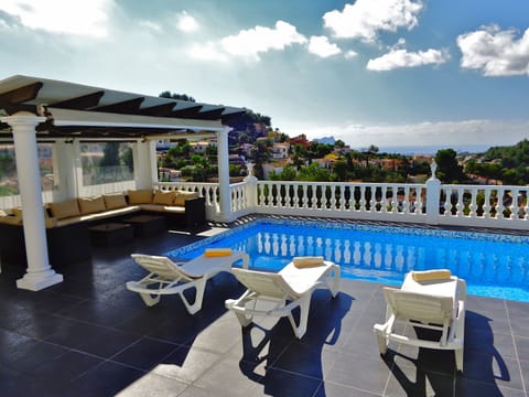 Sunbathe by the pool or read a book in the shaded lounging area 