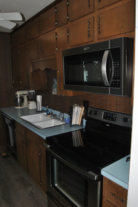 Galley kitchen with direct door to upper deck makes it convenient to grill. 