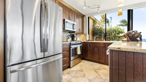 Side by side stainless fridge/freezer with ice maker.