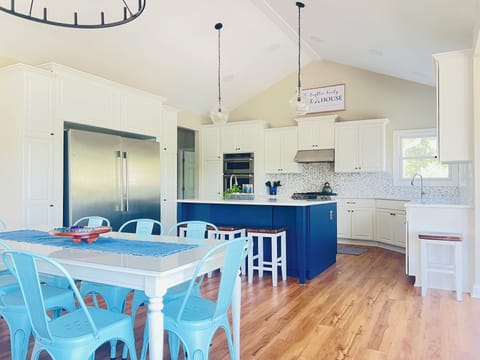 The kitchen has double appliances and another table for eight