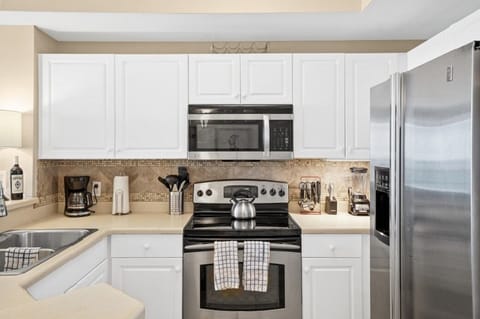 Full size kitchen with stainless steel appliances.