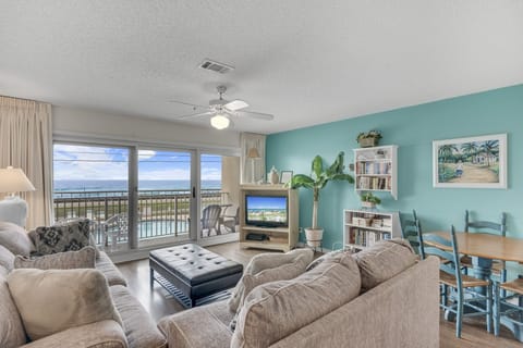 A cheerful living room with a smart TV and Gulf views.
