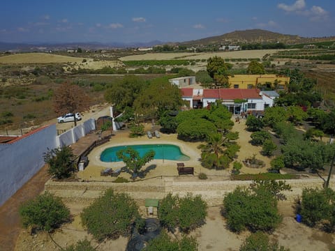 Aerial view of the Orange Grove apartment next to owners house, pool and garden.