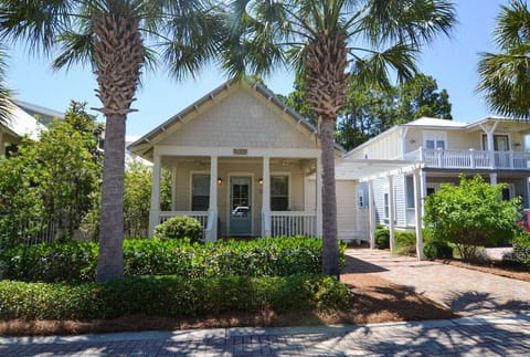 Charming single-story cottage with private driveway parking and a welcoming front porch.