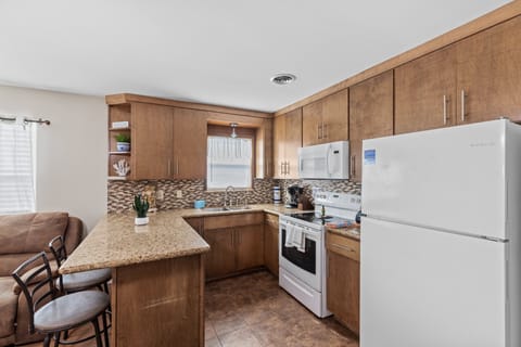 First unit fully stocked kitchen with bar seating