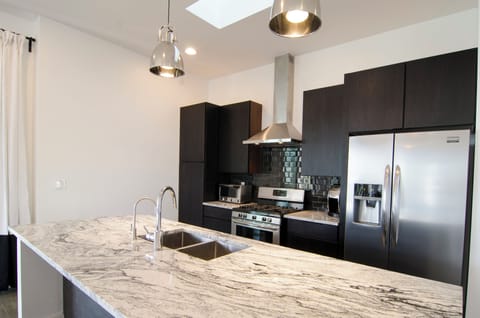 Well stocked kitchen designed for feeding a large group. Granite. Stainless.