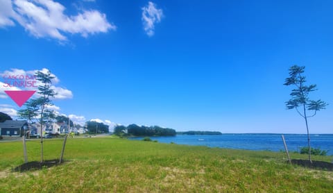 Large green-space/park across the street with water access and sweeping views.