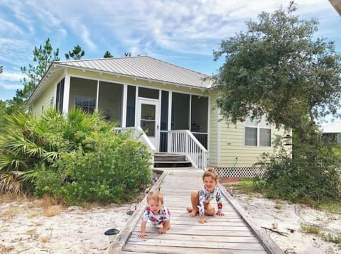 My beautiful granddaughter in front of the cottage