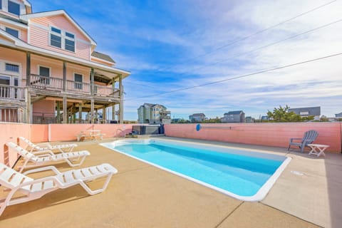 Dive into your private pool paradise, where comfortable loungers await your perfect beach house getaway.