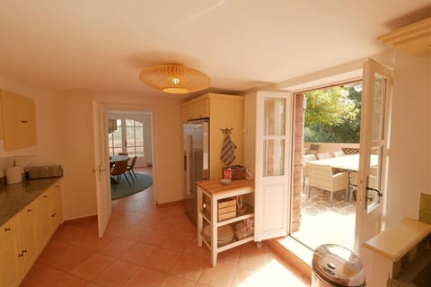 Kitchen double door to charming outdoor eating area.
