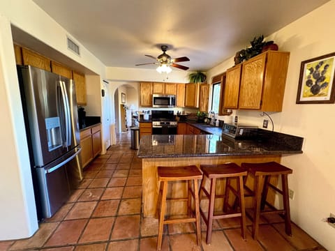 Well stocked kitchen, updated appliances, coffee station and breakfast bar