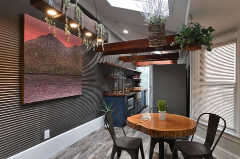 Rustic wall mural &amp; wood ceilings add warm character to this inviting dining space