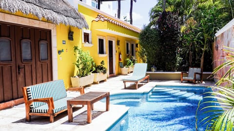 Mariposa has a palapa style roof and doors open to the pool.