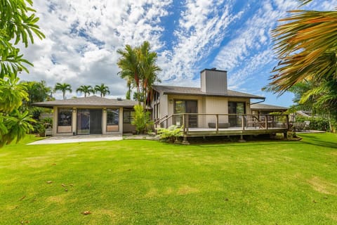 Enjoy the expansive lawn framed by tropical landscaping, perfect for games, lounging, or quiet afternoons.