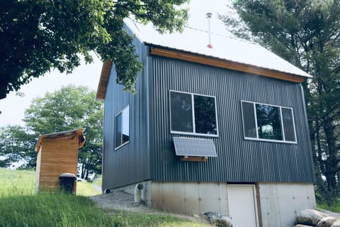 Large windows overlooking the surrounding forest and fields.