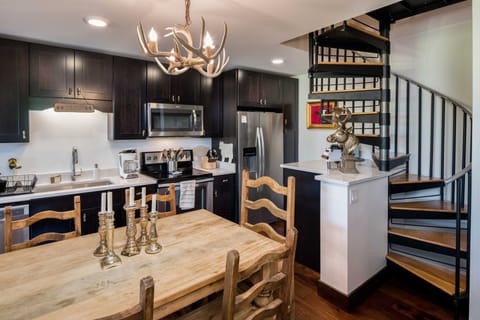 Dining table, kitchen and stairs to second floor