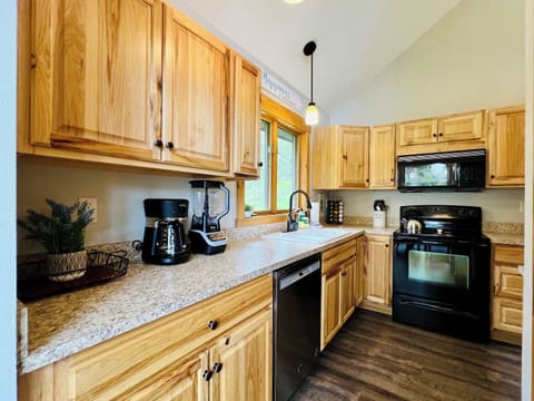Kitchen with dishwasher, stove, and fridge