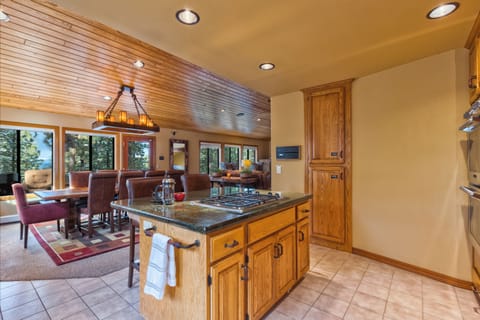Kitchen view into dining & filtered views of the lake