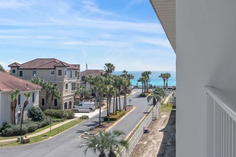 Sit back, relax, and take in the palm-lined street and sparkling Gulf beyond — just steps from Maravilla's private beach access.