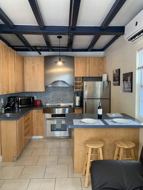 Open area full kitchen and breakfast bar 
