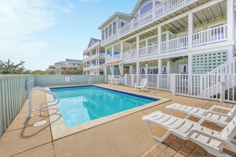 Large beach house with private pool and multiple balconies offers plenty of space for group gatherings and relaxation.