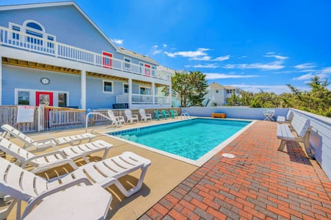 Dive into relaxation at your private pool oasis with ample seating and stunning coastal views.