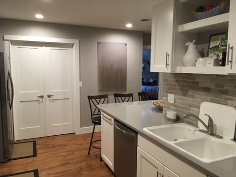 Kitchen with dishwasher and trash-recycle drawer.