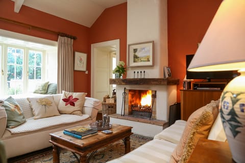 Warm Living Room with large open wood burning fireplace 