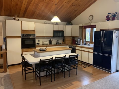 Large, fully applianced kitchen. View from dining area.