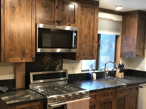 New custom alder cabinets with leathered granite counters