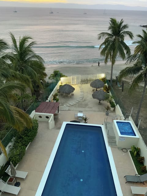 Deck view: pool, hot tub, shower, kitchen, grill and locking gates to the beach 