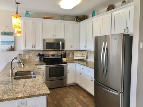 Fully equipped kitchen with drip coffee pot, blender, toaster, and more.