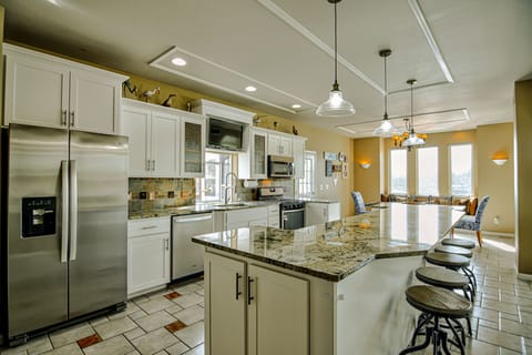 New stainless steel appliances, gas stove and TV above the garden window.