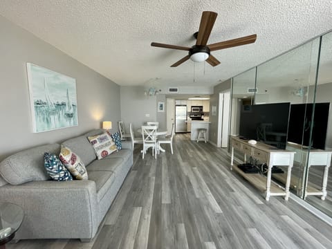 Living Room, Hardwood Floor, TV, Mirror, Ceiling Fan, Table, Couch, Pillows, Art