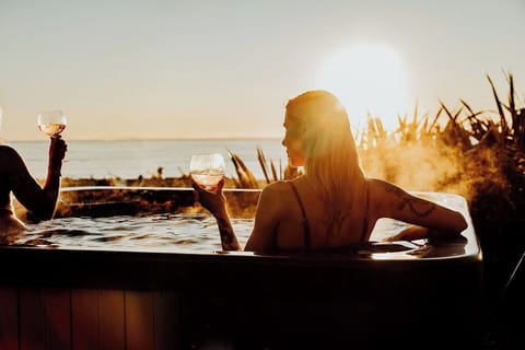 Relax in the private hot tub surrounded by nature. Perfect for a sunset soak or quiet evening under the stars.