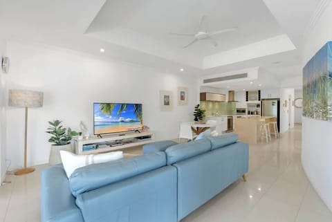 Unwind in the spacious, open-plan living area—bright, breezy, and designed for comfort with plenty of natural light and calming coastal décor.