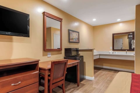 Hypo-allergenic bedding, desk, laptop workspace, blackout drapes