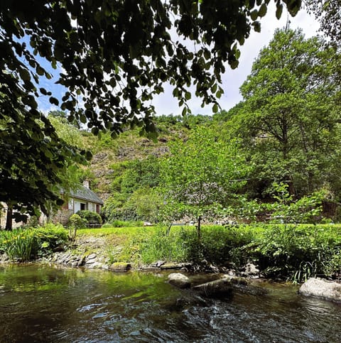 In the heart of the valley, house and wildflower covered cliffs tower up