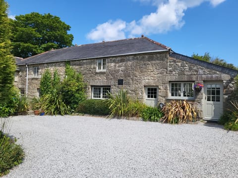 A Grade II listed granite barn conversion dating from the late 16th C
