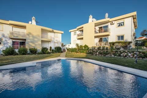 Outside area with large swimming pool and beautiful garden