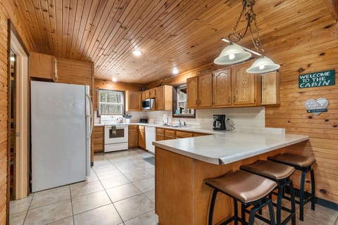 Large stocked kitchen with full size fridge, dishwasher and electric range