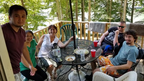 Deck on the cottage with a view of the water behind.