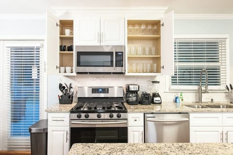 Modern kitchen comes fully stocked with all dinnerware, cookware, and utensils needed