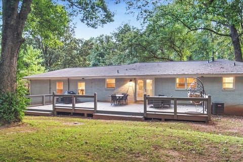 Spacious deck in the backyard with propane grill, outdoor dining area and lounge space